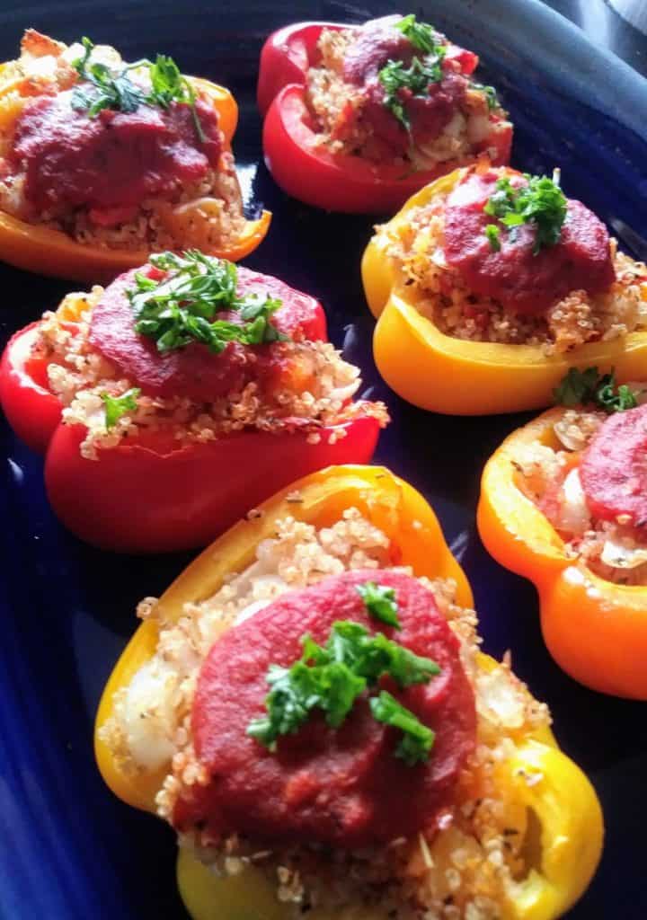 red, yellow, and orange bell pepper halves stuffed with butternut squash and quinoa
