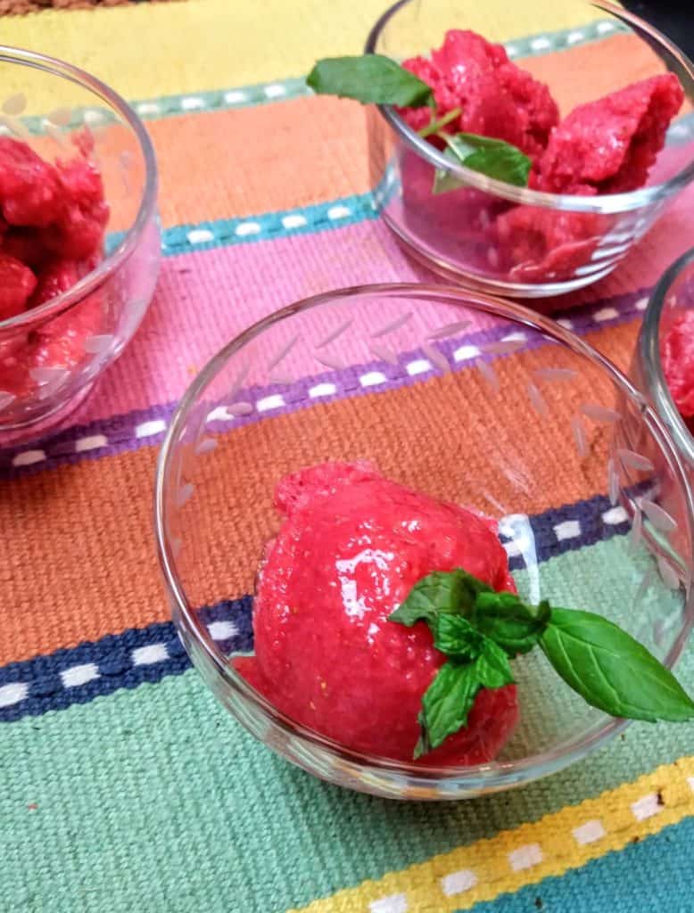 strawberry sorbet in glass dishes with mint leaves