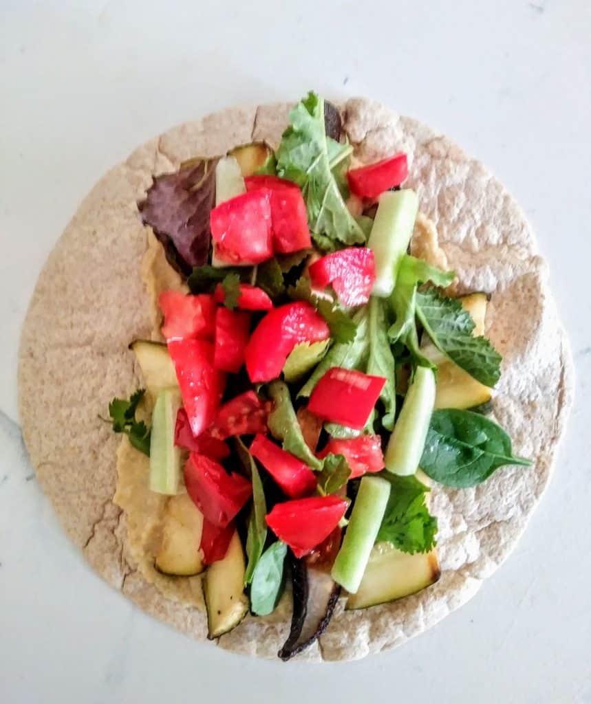 vegetables and hummus on whole wheat tortilla