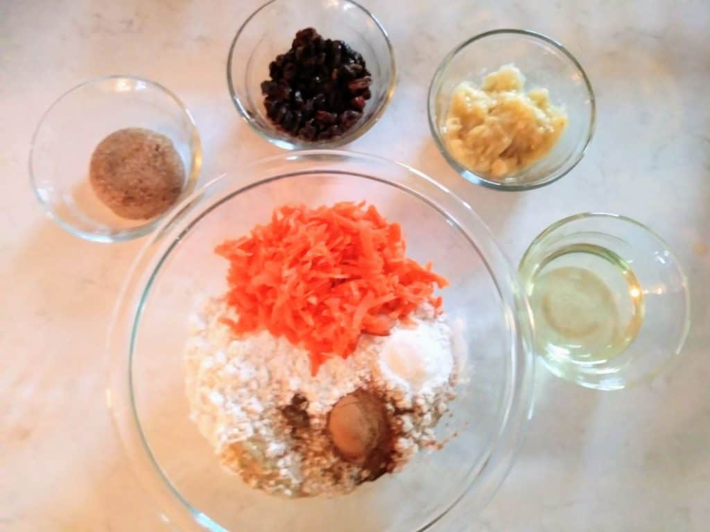 Carrot raisin ingredients in glass bowls