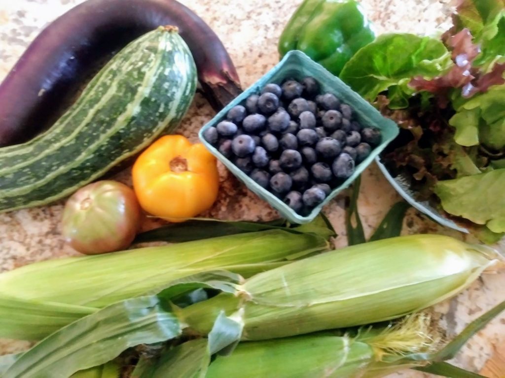 blueberries, corn, zucchini, eggplant, tomatoes, and salad greens