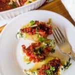 stuffed shells with kale and tomato sauce on plate