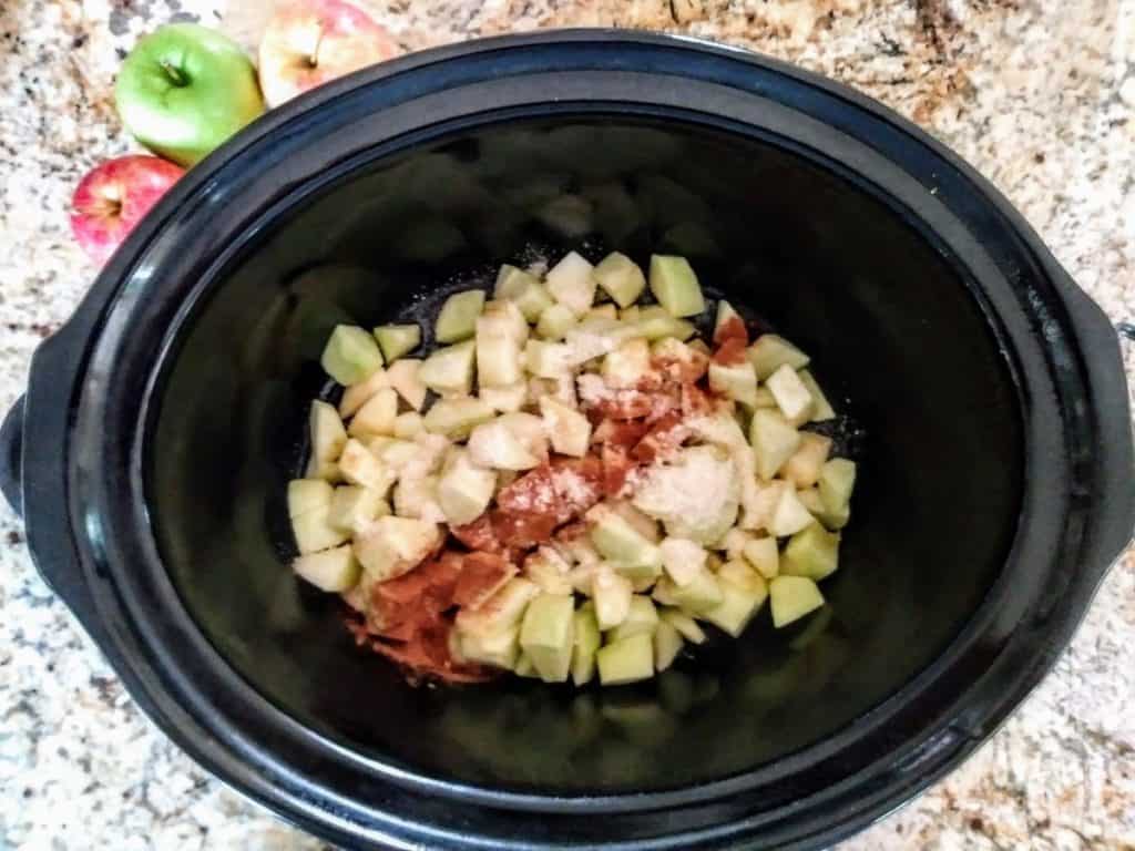 chopped apples with spices and almond flour in slow cooker