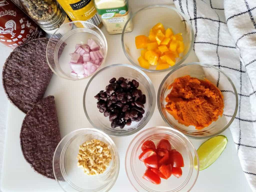 quick-pumpkin-and-black-bean-tacos-ingredients on white cutting board