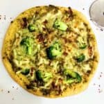 vegan broccoli pesto pizza with pizza wheel