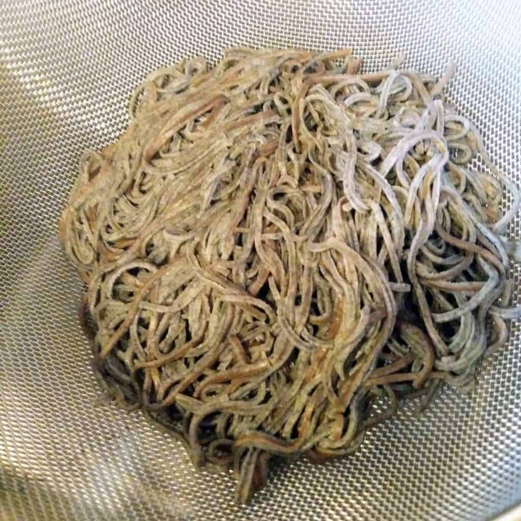 black soybean spaghetti in colander