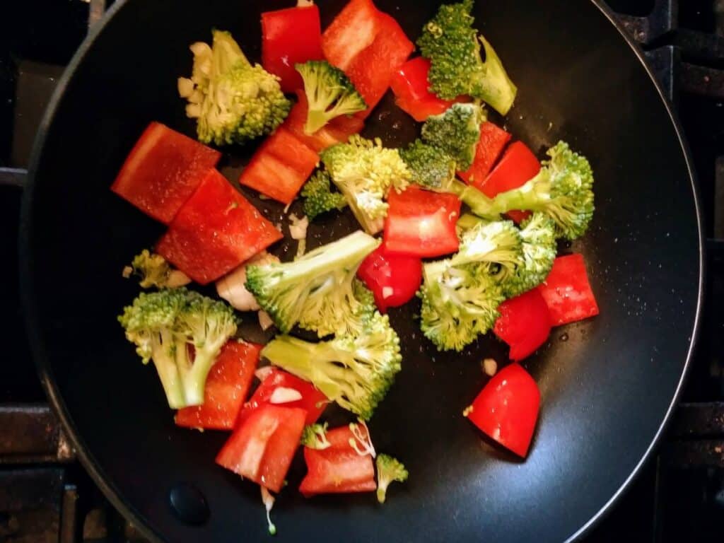 broccoli and red peppers in saute pan