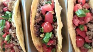 vegan smash tacos topped with pico de gallo.