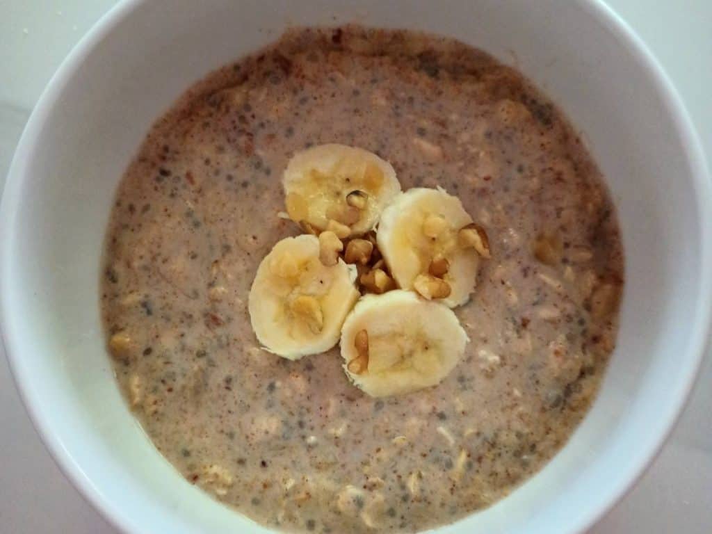 banana overnight oats with slices od banana and walnuts on top.