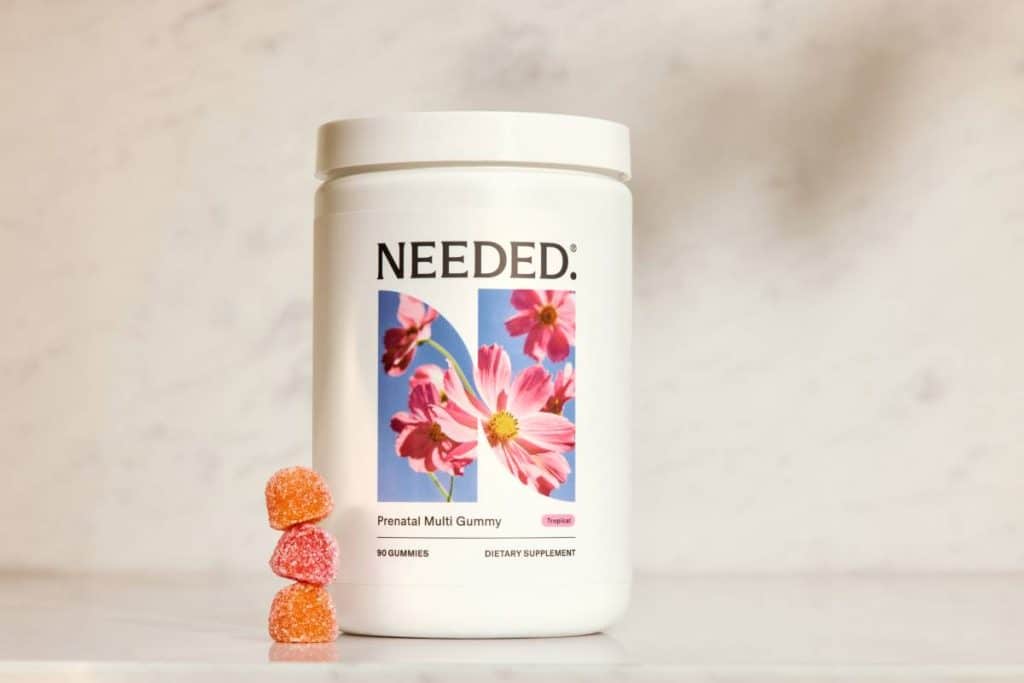 bottle of needed prenatal gummy vitamins with 3 gummies next to it.